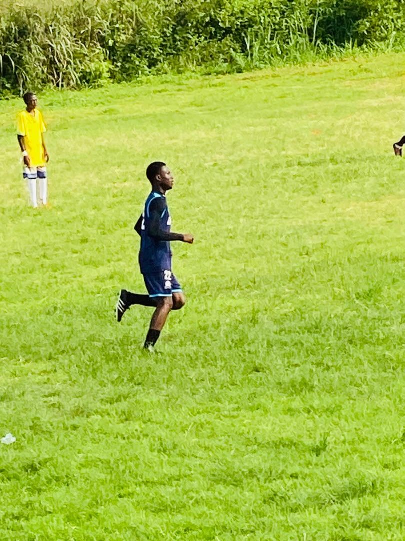 Academy player in navy kit running during training